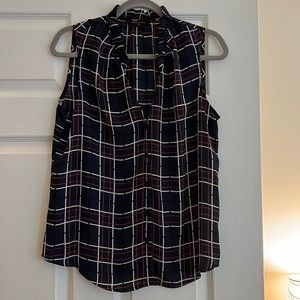Plaid, sleeveless button down top.
